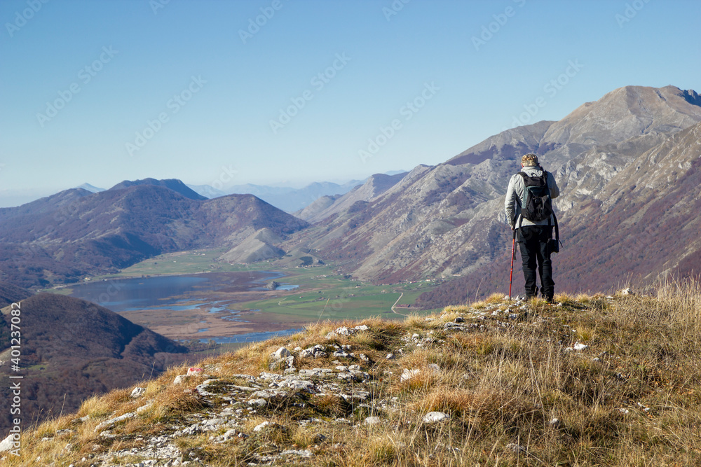 hiker in the mountains with lake in matese park