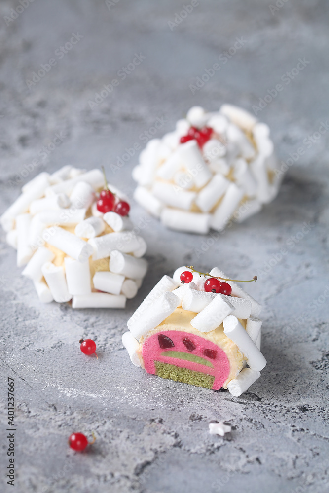 Contemporary Red Fruit and Matcha Tea Individual Mousse Cakes, decorated with Meringue Cookies, on a grey background. Contemporary Red Fruit and Matcha Tea Individual Mousse Cakes, decorated with Meringue Cookies, on a grey background.