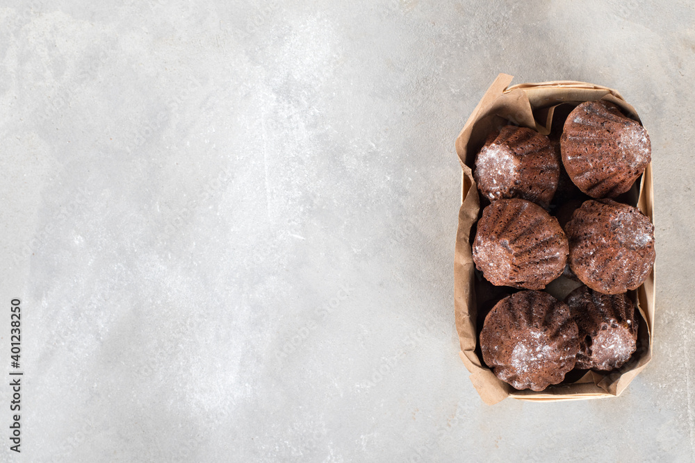 Chocolate cupcakes in a wooden box on a light gray background top view copy space Chocolate cupcakes in a wooden box on a light gray background top view copy space