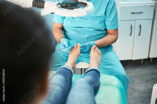 Patient visiting chiropodist podiatrist in beauty center photo