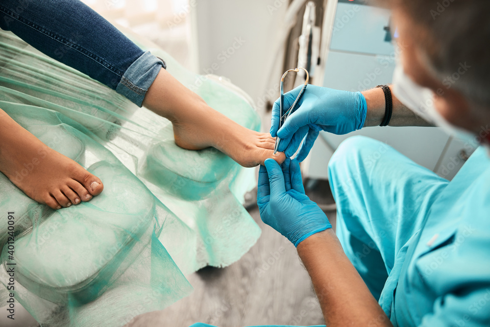 Female patient visiting podiatrist with pain on feet and toes Female patient visiting podiatrist with pain on feet and toes
