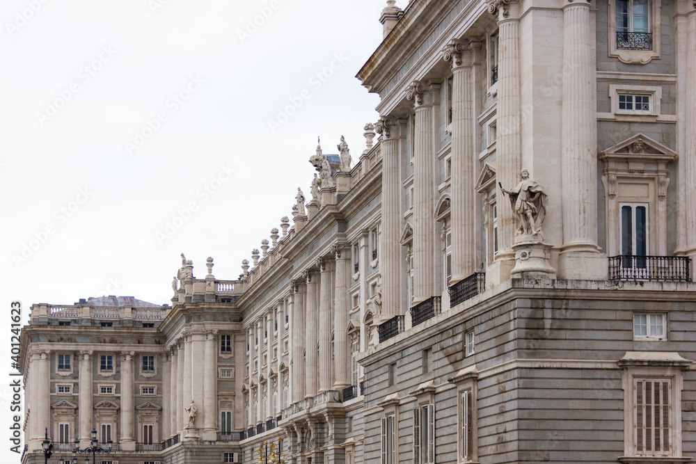 Side facade of Royal Palace on cloudy day in Madrid. Historical landmark in Spain capital. Tourist attraction, baroque style concepts