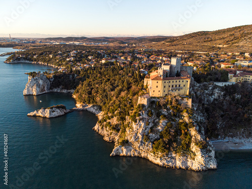 Aerial view of gothic Duino castle on a cliff over the Gulf of Trieste , Italy.  photo