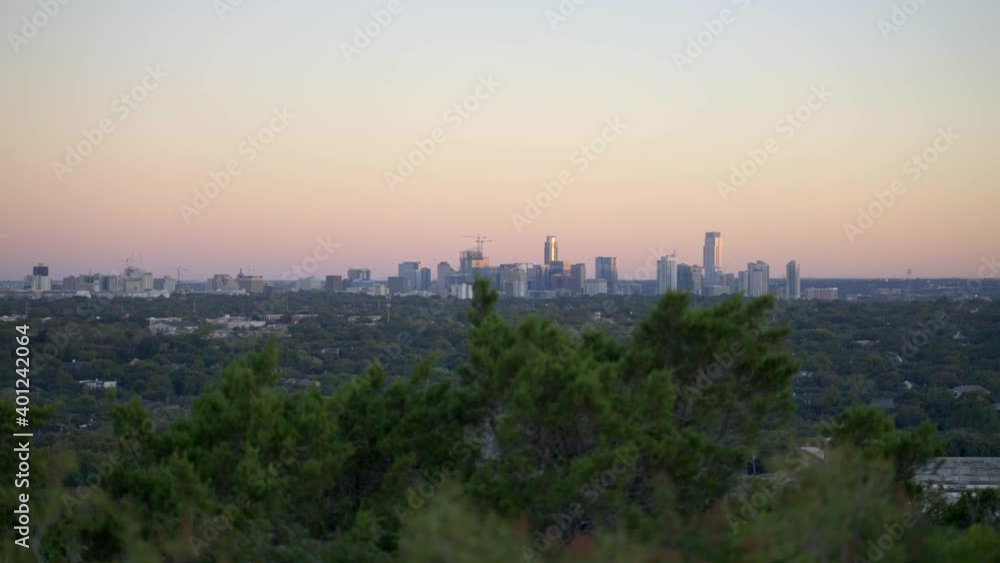 Handheld 4k slow motion establishing shot of the cityscape and buildings of Austin, Texas from public park in the warm, south American state Handheld 4k slow motion establishing shot of the cityscape and buildings of Austin, Texas from public park in the warm, south American state