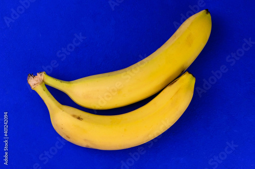 Two bananas on a blue background. Top view.