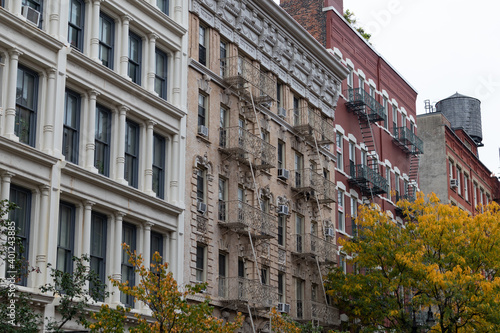 Row of Old Brick Apartment Buildings in SoHo of New York City with Colorful Trees during Autumn