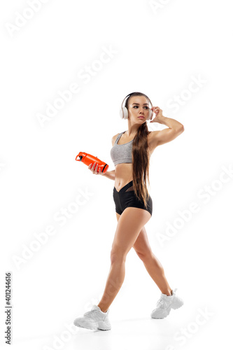 Step. Caucasian professional female athlete, runner training isolated on white studio background. Muscular, sportive woman. Concept of action, motion, youth, healthy lifestyle. Copyspace for ad.