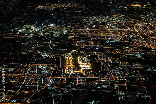 Beijing, capital of China, aerial view during night time, including Beijing Capital International Airport and streets are illuminated 