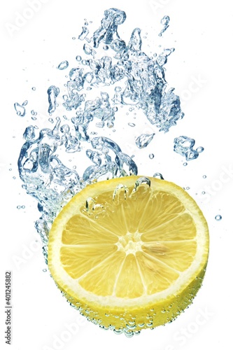 Fresh lemon dropped into water with splash isolated on white