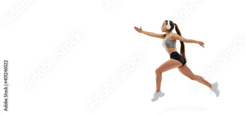 Fototapeta Naklejka Na Ścianę i Meble -  Flyer. Caucasian professional female athlete, runner training isolated on white studio background. Muscular, sportive woman. Concept of action, motion, youth, healthy lifestyle. Copyspace for ad.