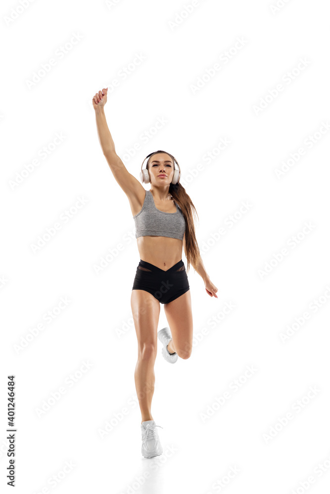 Winner. Caucasian professional female athlete, runner training isolated on white studio background. Muscular, sportive woman. Concept of action, motion, youth, healthy lifestyle. Copyspace for ad.
