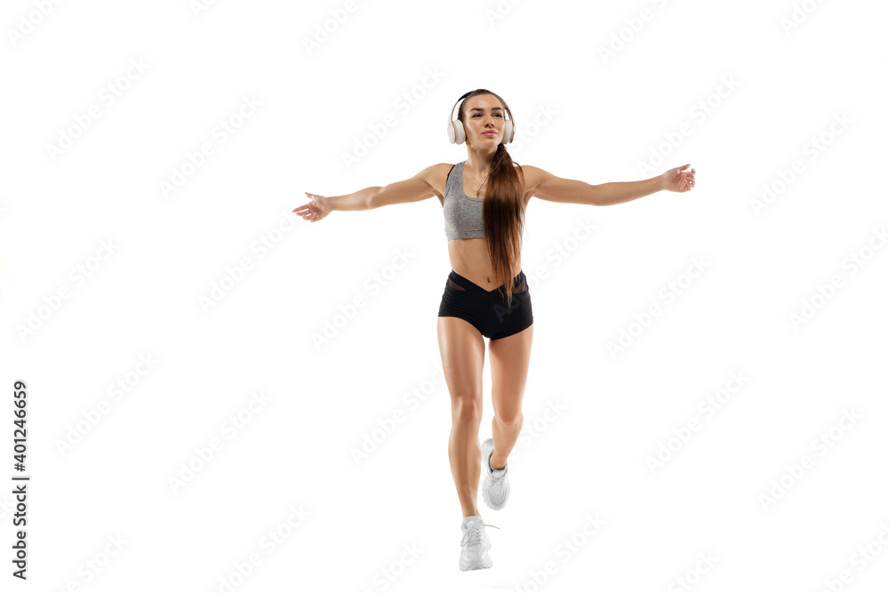 Dynamic. Caucasian professional female athlete, runner training isolated on white studio background. Muscular, sportive woman. Concept of action, motion, youth, healthy lifestyle. Copyspace for ad.