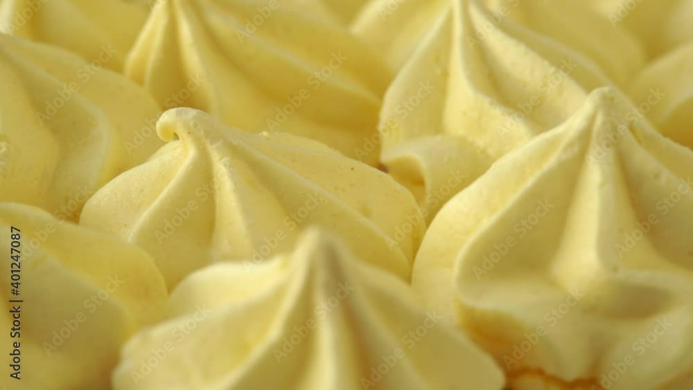 Macro close up of yellow citrus meringue rotates on tray. Food dessert background. Bakery and pastry shop concept Macro close up of yellow citrus meringue rotates on tray. Food dessert background. Bakery and pastry shop concept