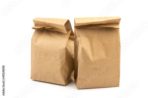 paper disposable bag of brown kraft paper on white background, concept of rejection of plastic packaging, template for designer, packaging for contactless product delivery