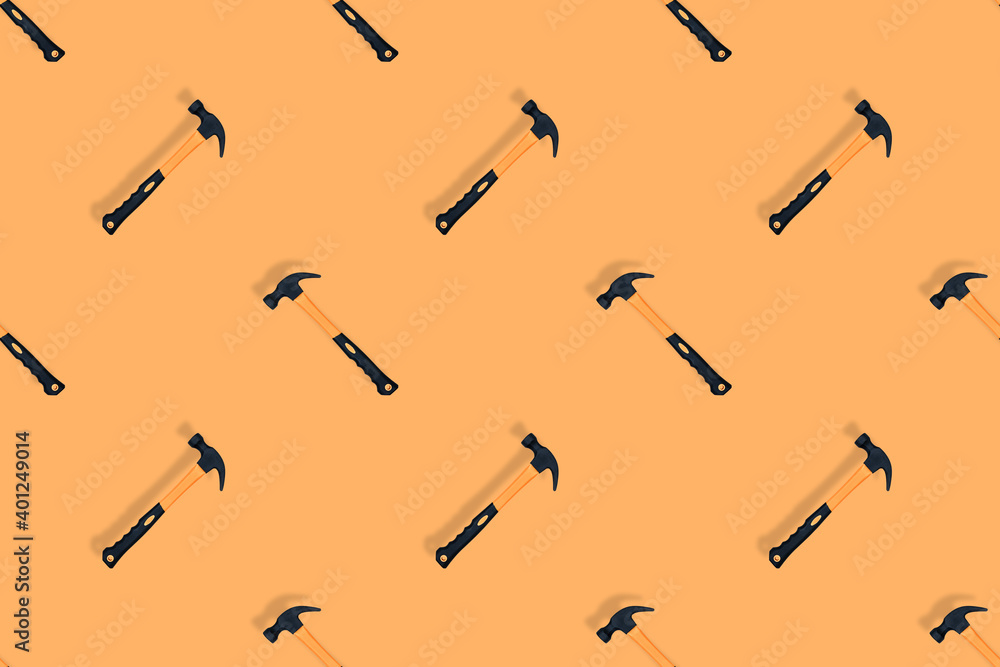 Hammer on an orange background. Hammer seamless pattern. Hammer on an orange background. Hammer seamless pattern.