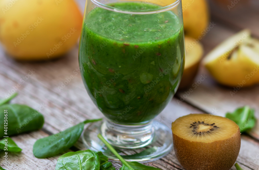 A glass of kiwi, spinach and apple smoothie. Health drink. Apples, flax seeds, spinach, kiwi, bananas lie nearby.
A glass of kiwi, spinach and apple smoothie. Health drink. Apples, flax seeds, spinach, kiwi, bananas lie nearby.