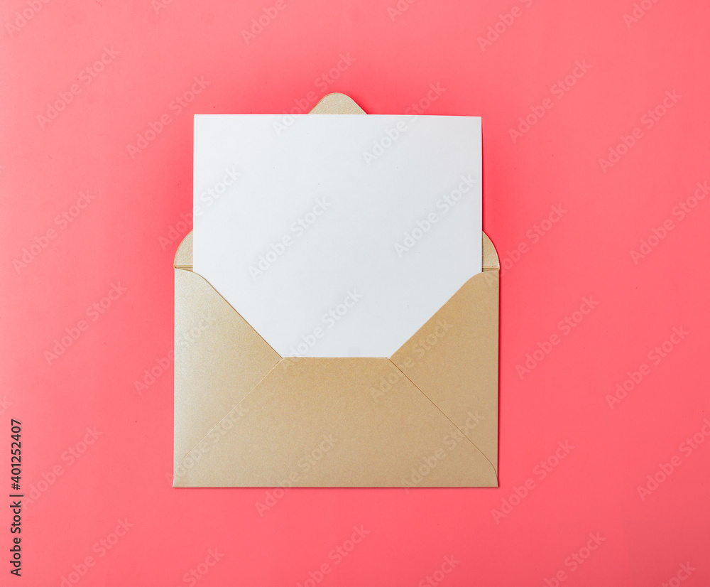 Opened gold envelope with white paper on a red background. Opened gold envelope with white paper on a red background.