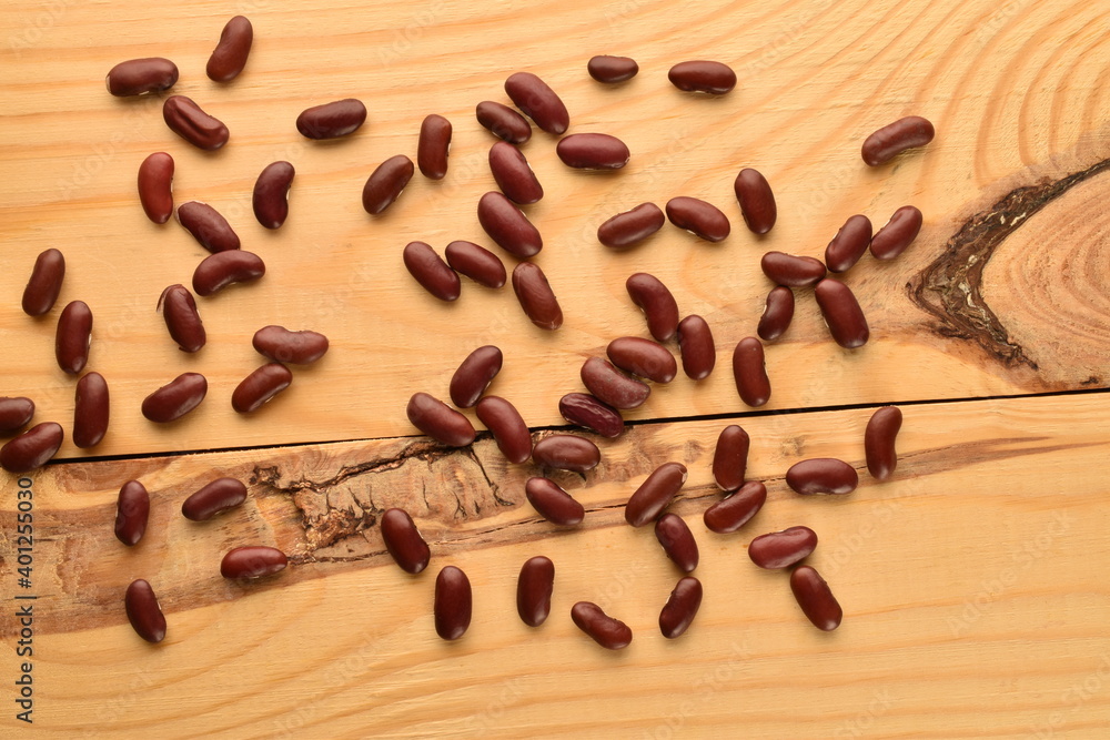 Not cooked organic, red beans, close-up, on a wooden table. Not cooked organic, red beans, close-up, on a wooden table.