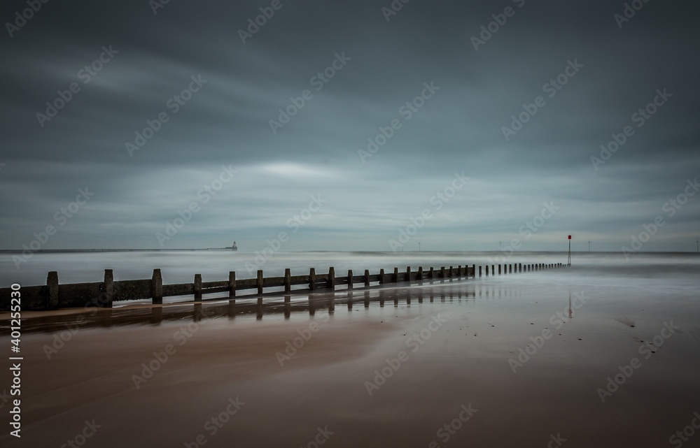 Fototapeta premium A stormy, cloudy and blustery day at Blyth beach in Northumberland, as the waves batter the coast