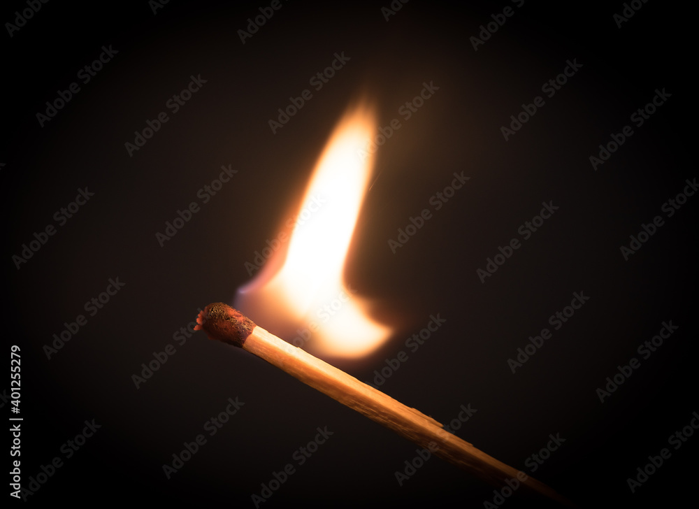 Fire burning on matchstick. Isolated on black background. Fire burning on matchstick. Isolated on black background.