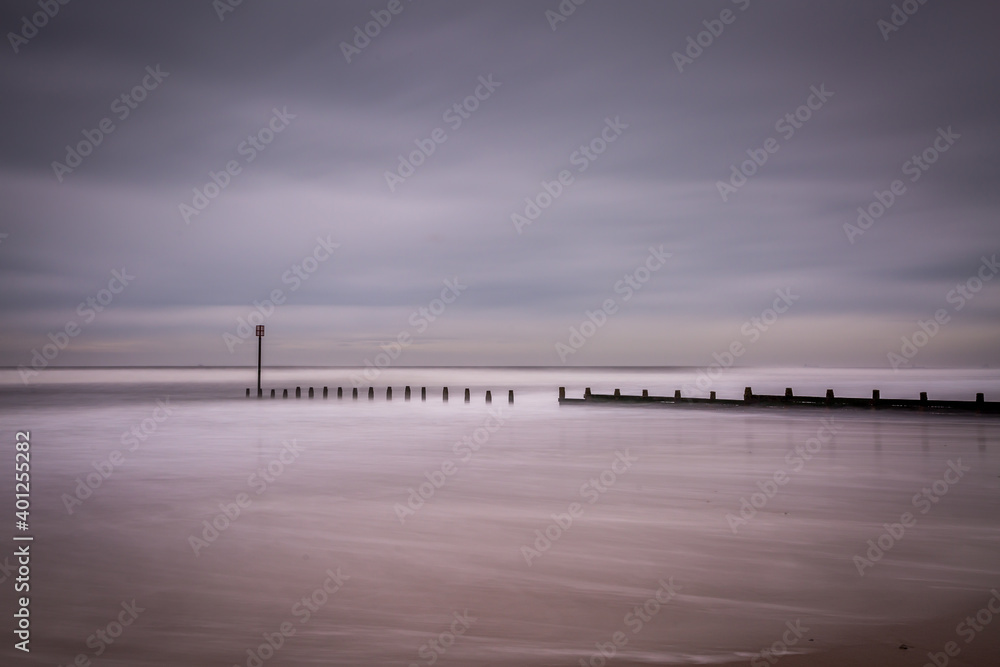 Fototapeta premium A stormy, cloudy and blustery day at Blyth beach in Northumberland, as the waves batter the coast