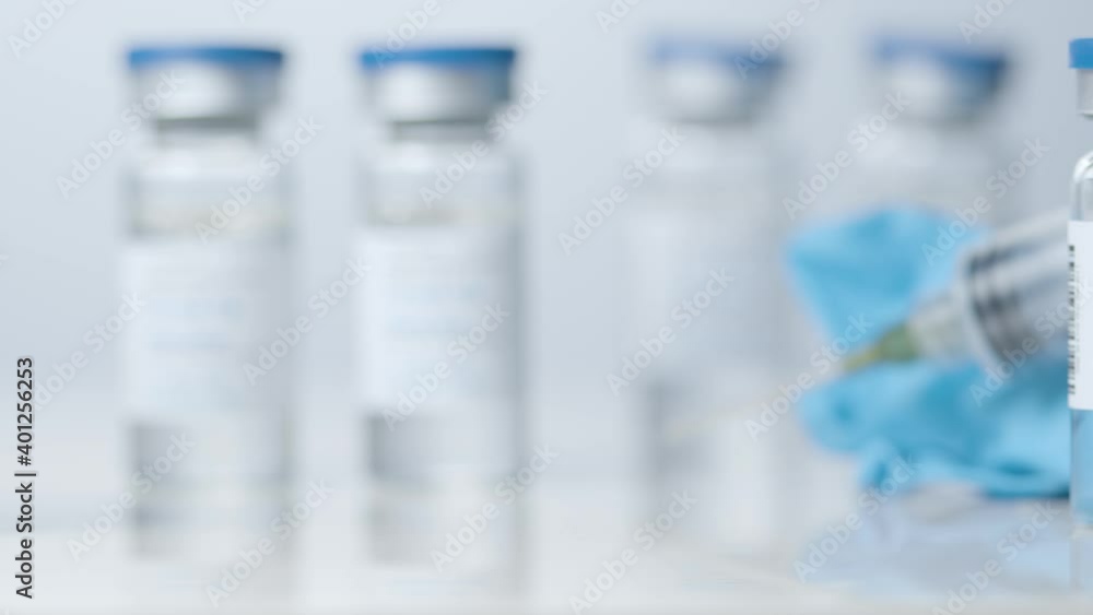 Sliding Close Up Shot of Four Vials Containing Covid 19 Vaccine Sliding Close Up Shot of Four Vials Containing Covid 19 Vaccine