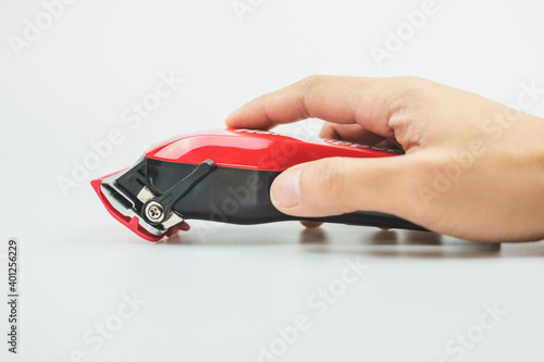 A hairstyle machine. Barbershop. Hair clipper in hand isolated on white background photo