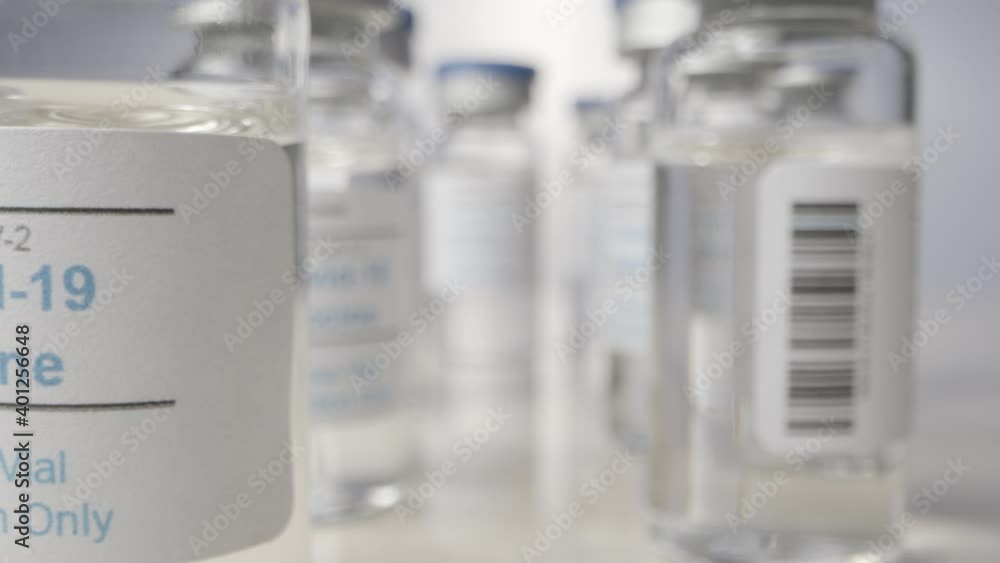 Sliding Extreme Close Up Shot Through Several Vials of Covid 19 Vaccine Sliding Extreme Close Up Shot Through Several Vials of Covid 19 Vaccine