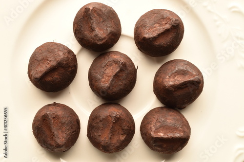 Wallpaper Mural Several delicious chocolate truffles on white ceramic dishes, close-up. Torontodigital.ca