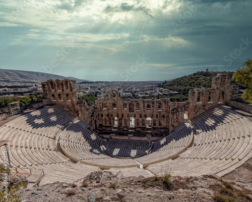 Herodeon ancient open theatre and Athens city panoramic view under dramatic cloudy sky, Greece photo