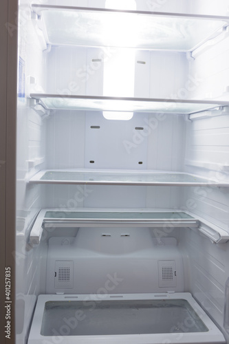 Empty refrigerator cabinet showcasing corona crisis leading to shortage of food