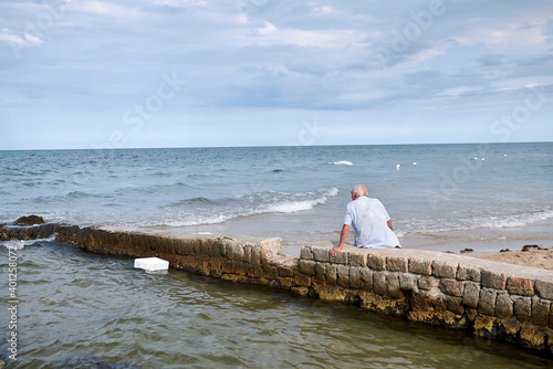 Lido Morelli, Italy - September 03, 2020 : Man resting by the sea photo