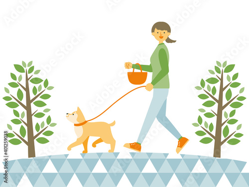 公園で犬の散歩をする女性