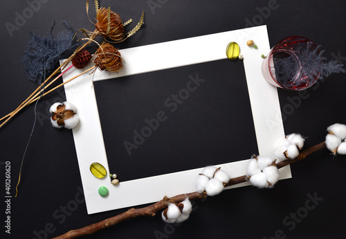 Bild auf Leinwand Background flatlay white frame on a black sheet with decor.