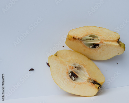 one sliced yellow quince with seeds photo