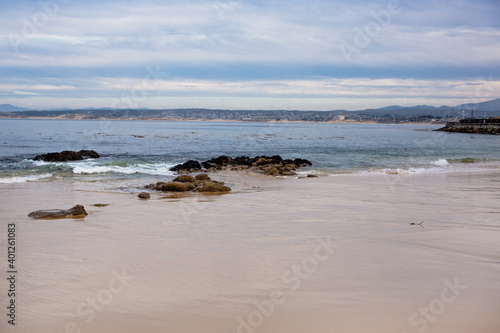 The Pacific Ocean coast in the city of Monterey in California. United States of America. Beautiful beach on a sunny day. Ocean landscape.
