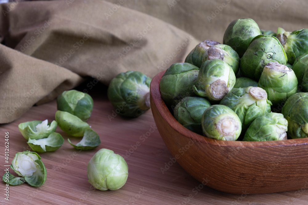 ripe Brussels sprouts lie in a wooden bowl ripe Brussels sprouts lie in a wooden bowl