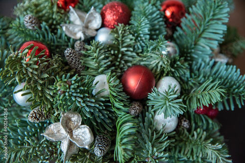 Beautifully decorated with a branch of the Christmas tree. A coniferous branch is decorated with balloons and toys, a new year's composition.