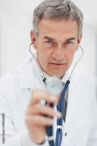 Doctor using stethoscope photo