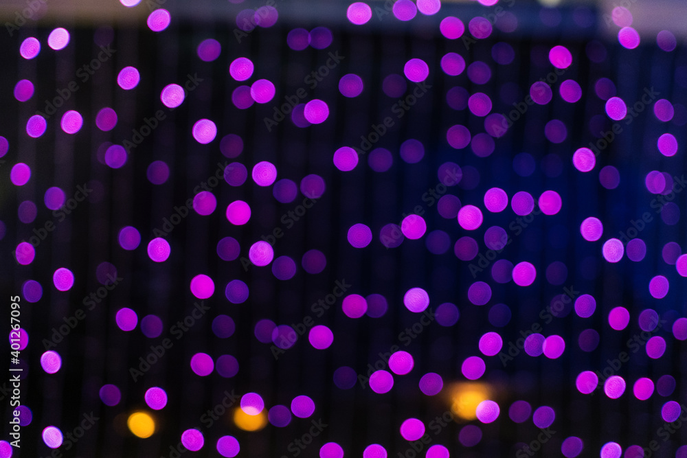 Christmas and New Year festive glitter bokeh background with purple or pink color.