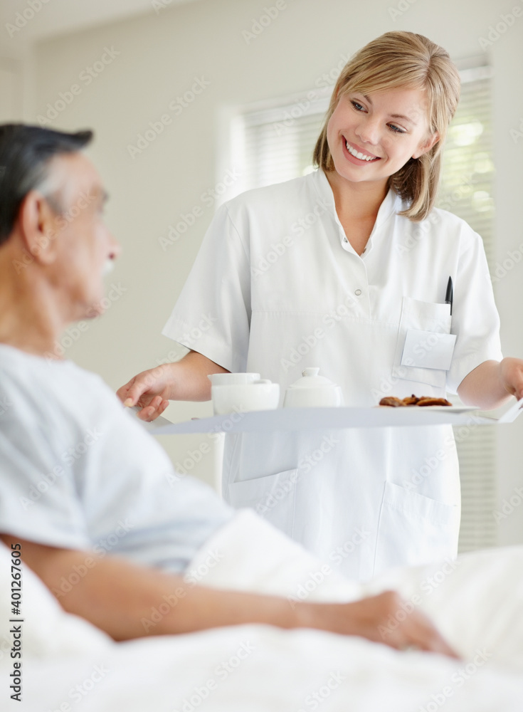 Nurse giving tray of food to patient Nurse giving tray of food to patient