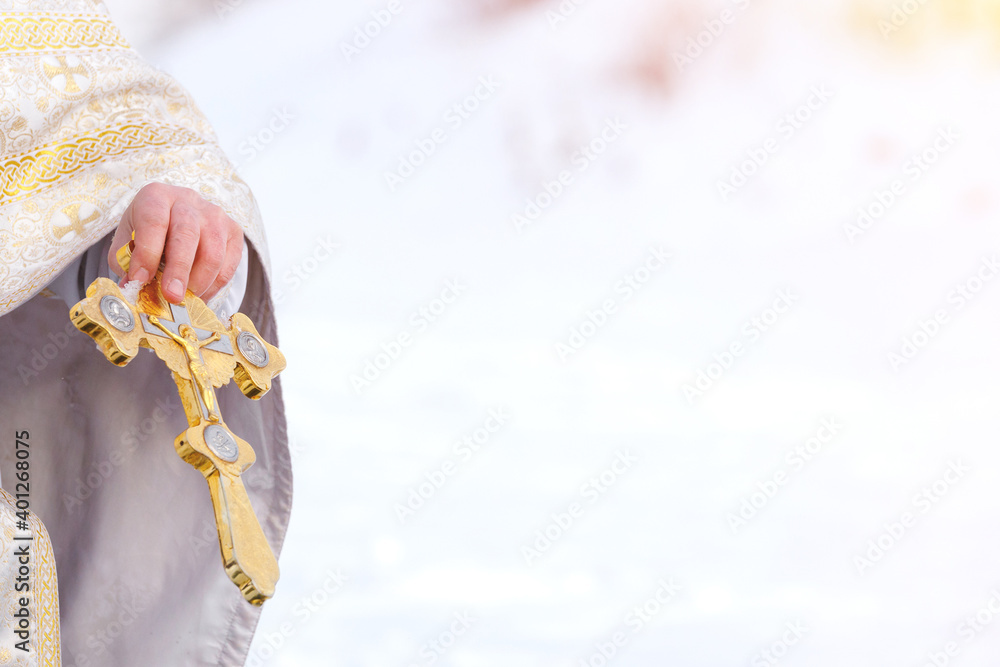 Priest holds golden cross in his hands. Copy space. Priest holds golden cross in his hands. Copy space.