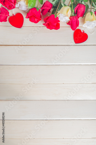 Wooden background with roses and hearts. Valentine day, Birthday, Woman Spring Holiday background, Mother’s day concept. Flatlay top view with copy space for text