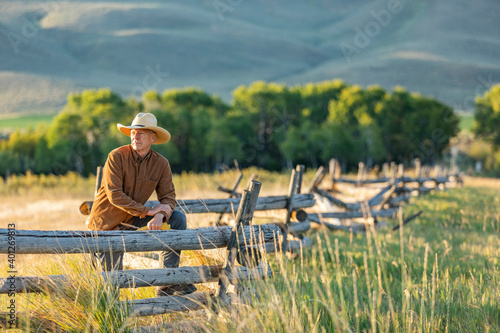 USA, Idaho, Bellevue, Rancher leaning against fence on field photo