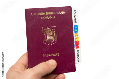 Romanian passport in hand, isolated on white background. photo