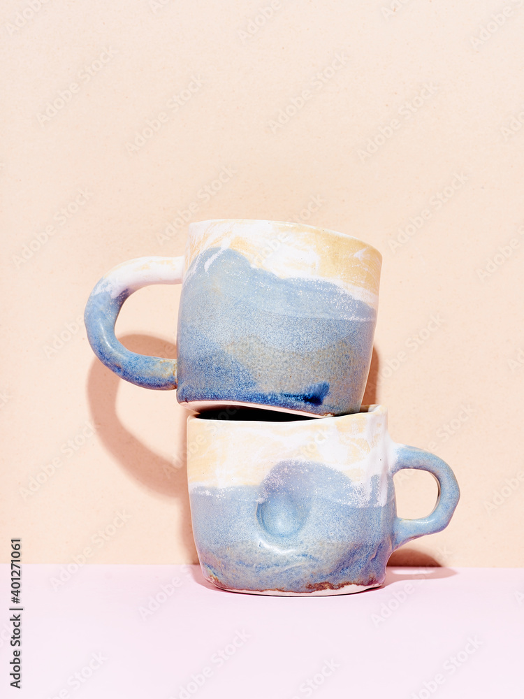 Still life of handmade ceramic mugs on bright studio background Still life of handmade ceramic mugs on bright studio background