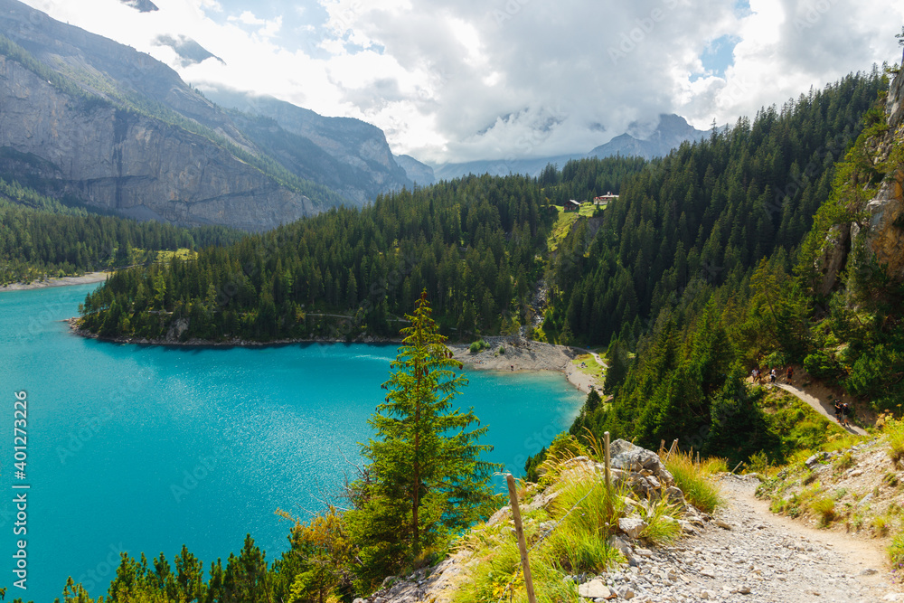 Obraz premium beautiful blue lake Oeschinensee in the Swiss Alps, with mountains in the background