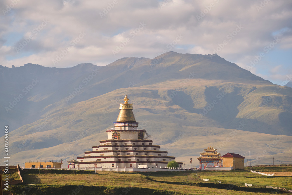 Multi tiered palace of Sichuan province in religious residence in green foggy cloudy mountains and hills Multi tiered palace of Sichuan province in religious residence in green foggy cloudy mountains and hills