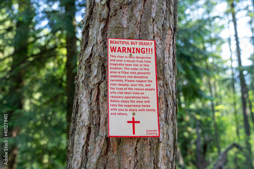 Warning sign at Kootenai Falls park, cautions visitors not to swim in the dangerous river