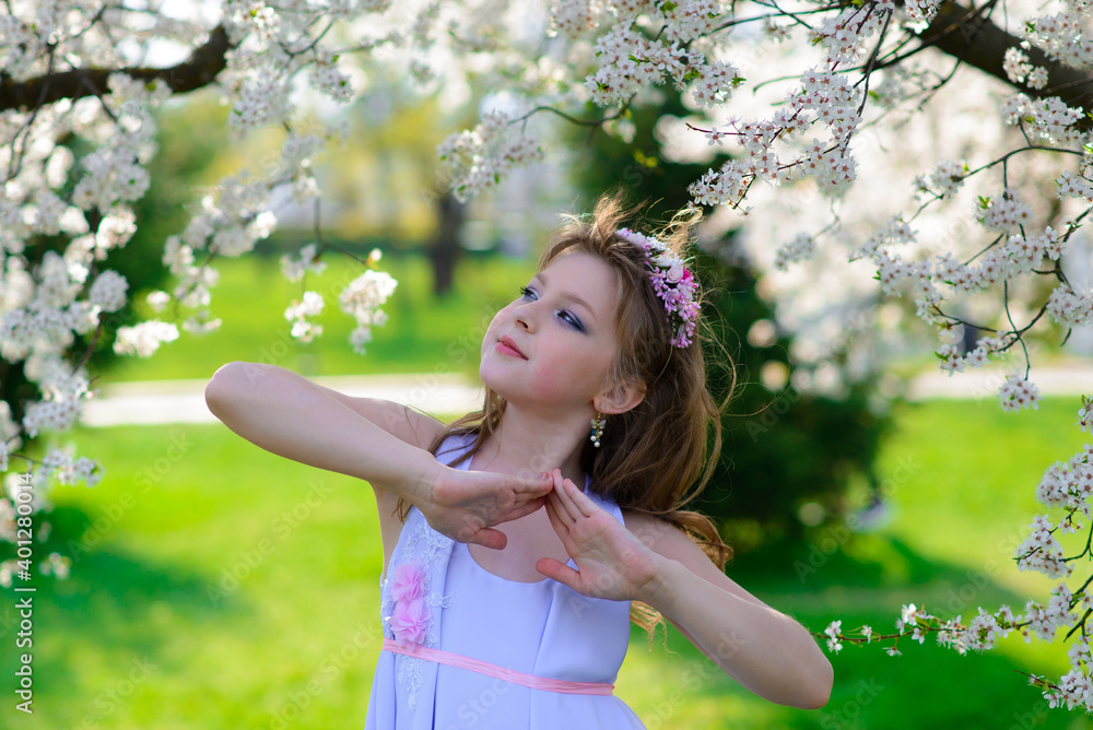 Pretty little girl in blooming apple tree garden on beautiful spring day Pretty little girl in blooming apple tree garden on beautiful spring day